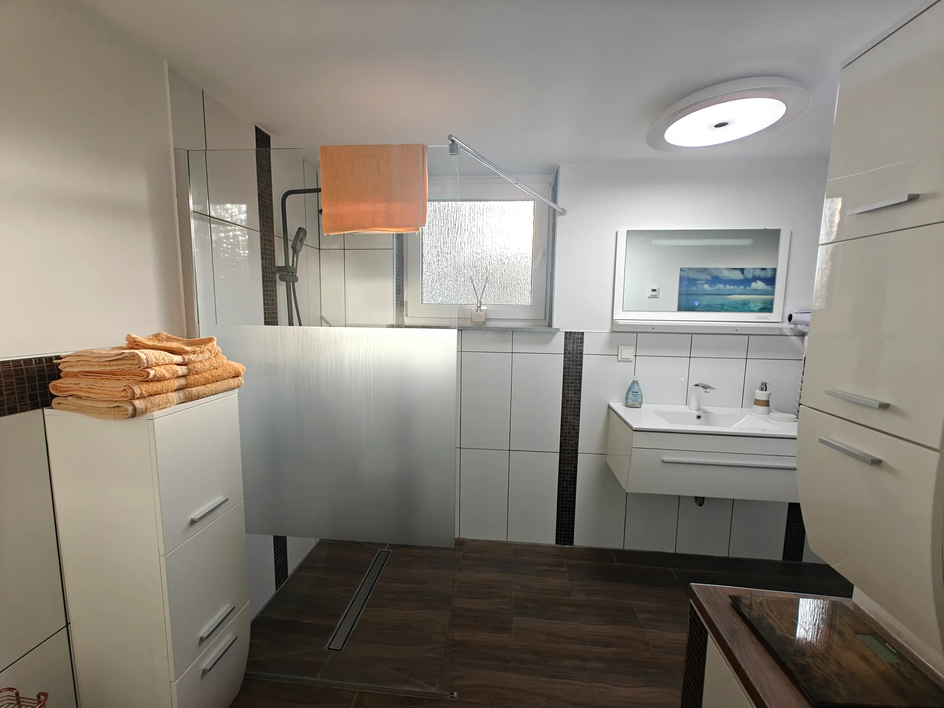 Bright shower room with a walk-in shower and washbasin