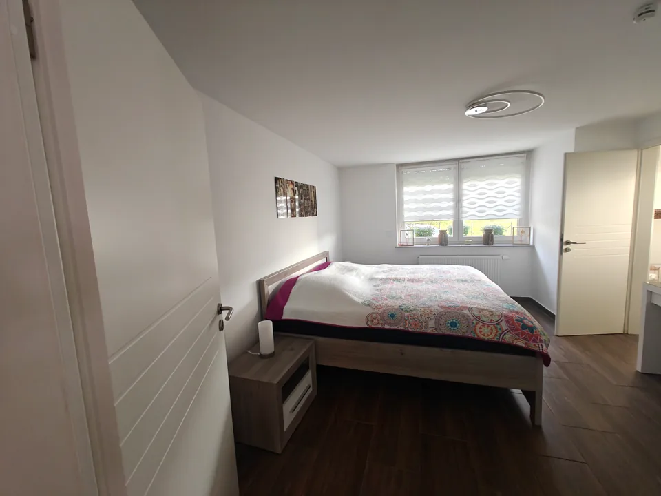 First bedroom with a king-size bed and bedside tables