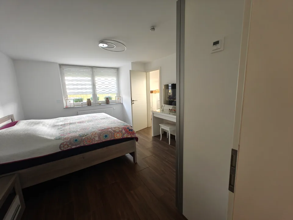 Bedroom with a king-size bed, bedside tables and a dressing table