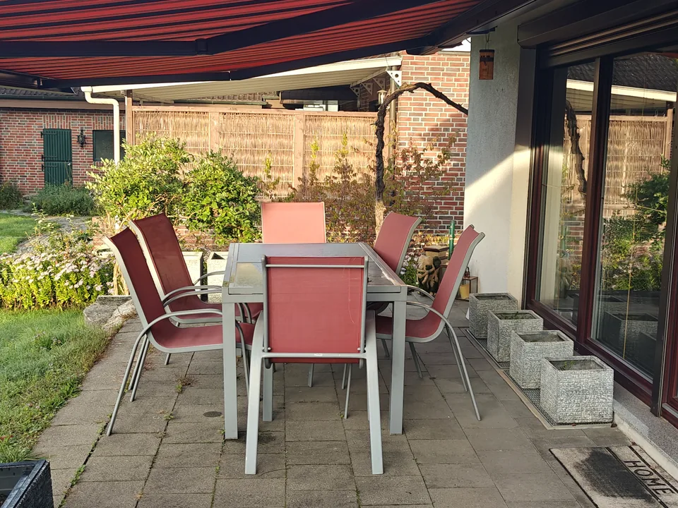 Terrace with a garden table under the awning